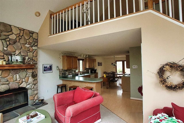 3330 Commodore Dr, East Jordan, MI 49727 - living room with high vaulted ceiling and a fireplace