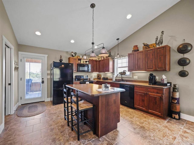 10300 Vista Ridge Dr, Alden, MI 49612 - kitchen with black appliances, a sink, a breakfast bar area, baseboards, and a kitchen island