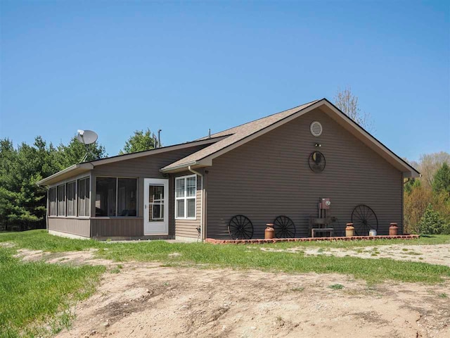 10300 Vista Ridge Dr, Alden, MI 49612 - view of home's exterior featuring a sunroom