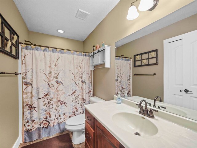 10300 Vista Ridge Dr, Alden, MI 49612 - bathroom with toilet, vanity, and a shower with shower curtain