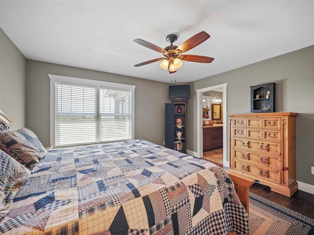 10300 Vista Ridge Dr, Alden, MI 49612 - bedroom with wood finished floors, baseboards, ceiling fan, and ensuite bath