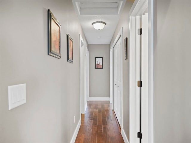 10300 Vista Ridge Dr, Alden, MI 49612 - hallway featuring dark wood finished floors, baseboards, and attic access