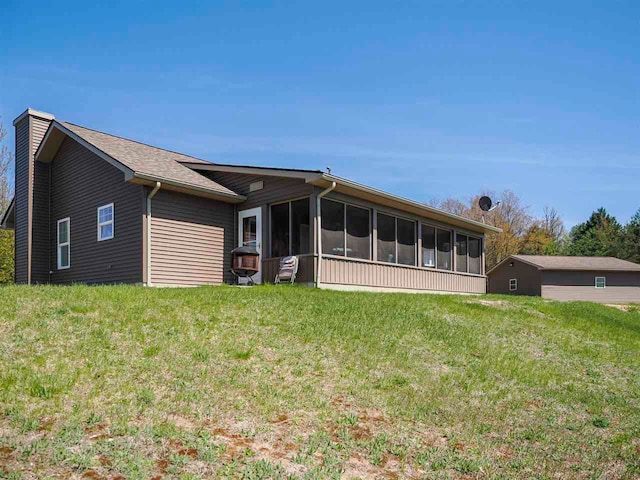 10300 Vista Ridge Dr, Alden, MI 49612 - back of house featuring a sunroom, a lawn, and a chimney