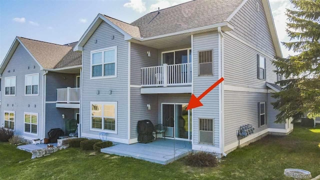 1564 Emerald Ct Unit 85, Petoskey, MI 49770 - back of property featuring a lawn, a balcony, a patio, and a shingled roof