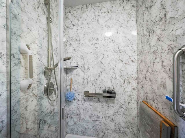 1564 Emerald Ct Unit 85, Petoskey, MI 49770 - full bathroom featuring a marble finish shower
