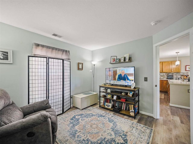 1564 Emerald Ct Unit 85, Petoskey, MI 49770 - living area with light wood-style floors and baseboards