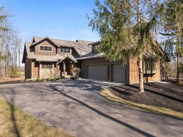 6092 Quarry Ridge Dr Unit 7, Bay Harbor, MI 49770 - view of front of property with driveway, a garage, and stone siding