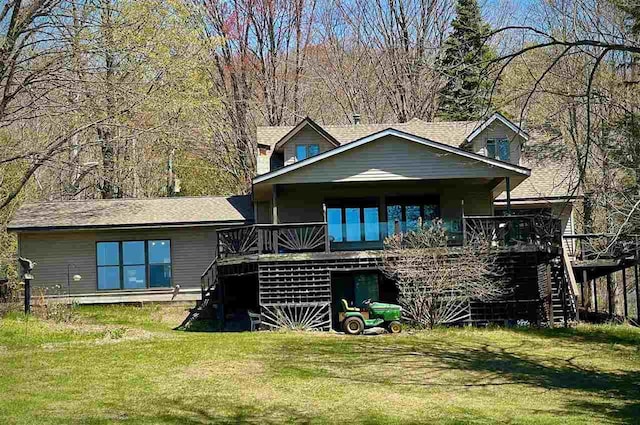 9690 Lake St, Ellsworth, MI 49729 - rear view of property with stairs, a deck, and a yard