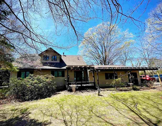9690 Lake St, Ellsworth, MI 49729 - view of front facade featuring a front yard and a wooden deck