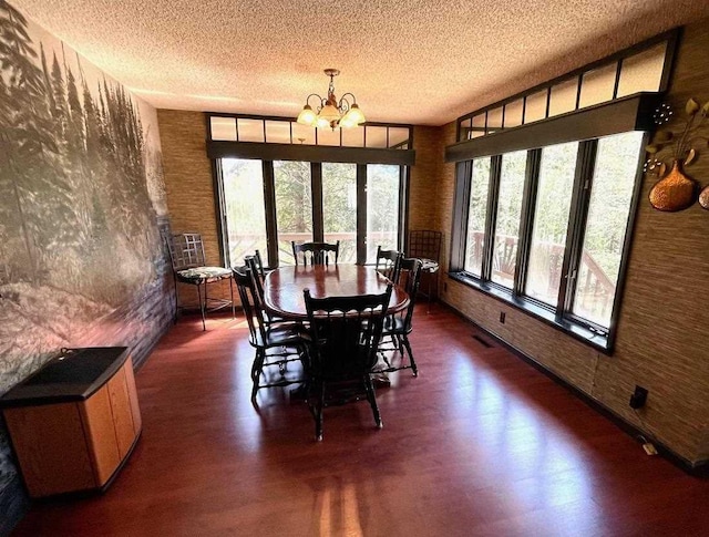 9690 Lake St, Ellsworth, MI 49729 - dining space featuring a chandelier, dark wood-type flooring, and a textured ceiling