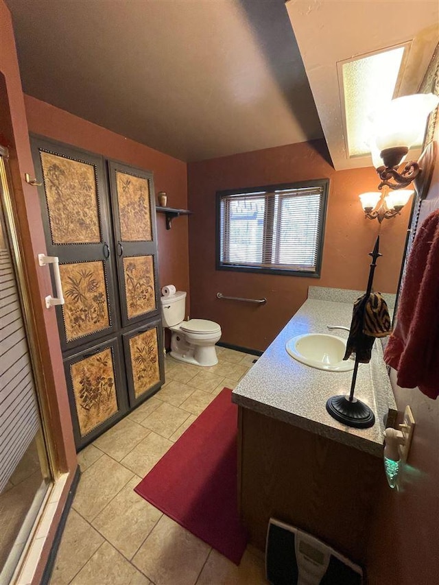 9690 Lake St, Ellsworth, MI 49729 - bathroom featuring tile patterned floors, toilet, a shower stall, and vanity