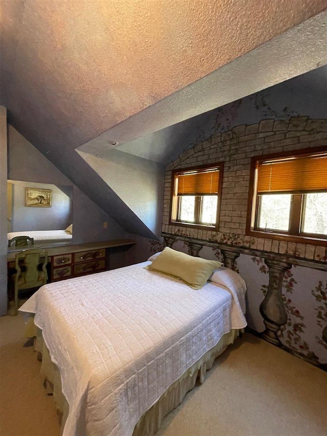9690 Lake St, Ellsworth, MI 49729 - carpeted bedroom featuring lofted ceiling and a textured ceiling