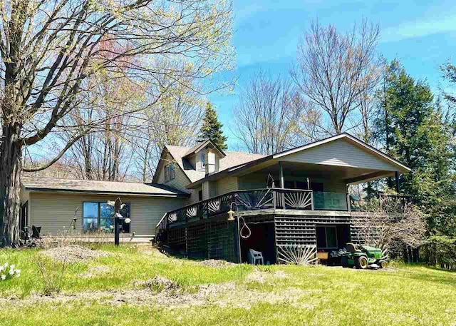 9690 Lake St, Ellsworth, MI 49729 - rear view of house featuring a deck and a lawn