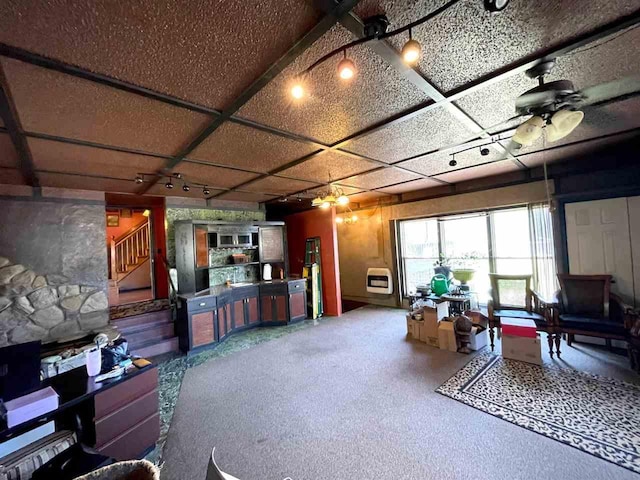 9690 Lake St, Ellsworth, MI 49729 - living area with ceiling fan, heating unit, and stairway
