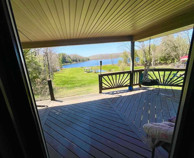 9690 Lake St, Ellsworth, MI 49729 - wooden terrace featuring a water view and a lawn