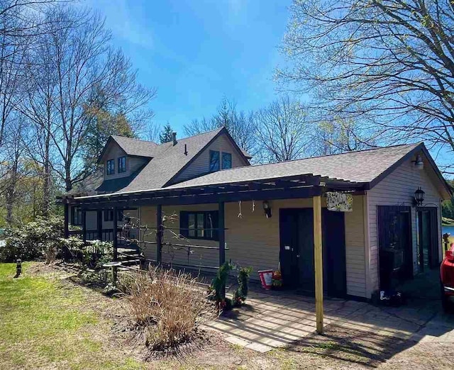 9690 Lake St, Ellsworth, MI 49729 - view of front facade with a porch and a shingled roof