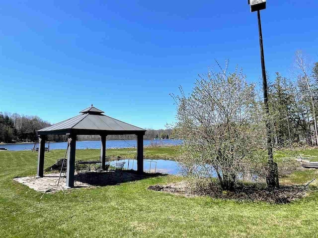 9690 Lake St, Ellsworth, MI 49729 - dock area featuring a gazebo, a yard, and a water view