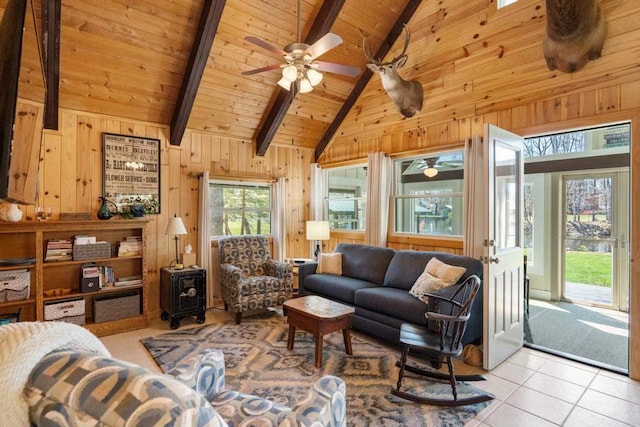 living area featuring wood ceiling, beam ceiling, light tile patterned flooring, wooden walls, and a wood stove