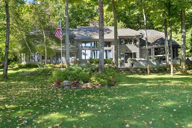 1442 Indian Point Rd, Brutus, MI 49716 - view of front of home with a front lawn and a chimney