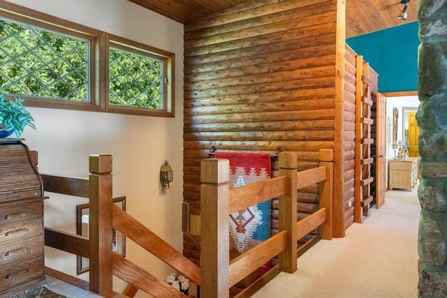 1442 Indian Point Rd, Brutus, MI 49716 - staircase featuring wood ceiling, log walls, and carpet floors