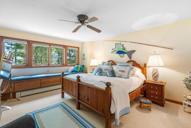 1442 Indian Point Rd, Brutus, MI 49716 - bedroom with baseboard heating, multiple windows, light colored carpet, and a ceiling fan
