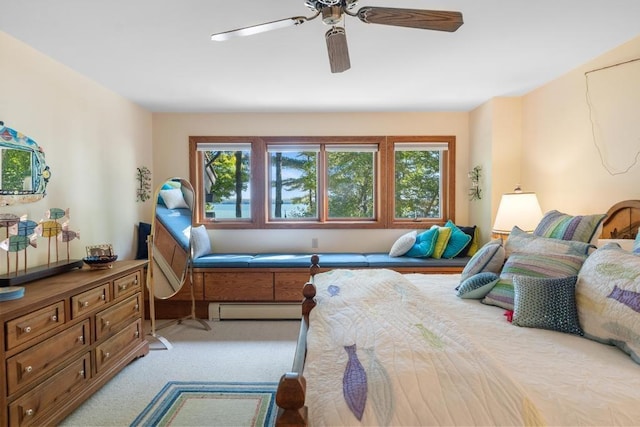 1442 Indian Point Rd, Brutus, MI 49716 - bedroom with baseboard heating, a ceiling fan, and light colored carpet