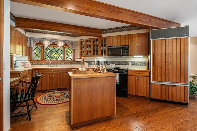 1442 Indian Point Rd, Brutus, MI 49716 - kitchen with black appliances, dark wood-style floors, brown cabinets, and beamed ceiling
