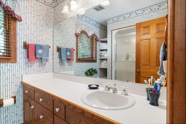 1442 Indian Point Rd, Brutus, MI 49716 - full bathroom with wallpapered walls, vanity, and a stall shower