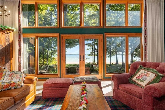 1442 Indian Point Rd, Brutus, MI 49716 - sunroom with a water view, french doors, plenty of natural light, and a high ceiling