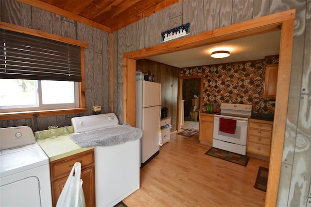 washroom with wood ceiling, light wood finished floors, independent washer and dryer, and wood walls