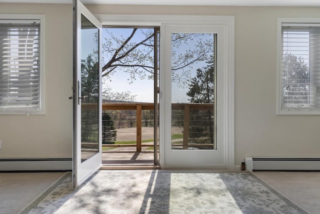 entryway featuring a baseboard heating unit and carpet floors
