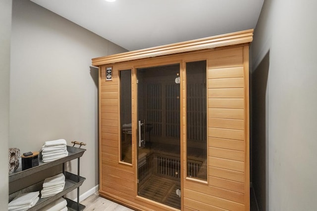 sauna featuring wood finished floors and baseboards
