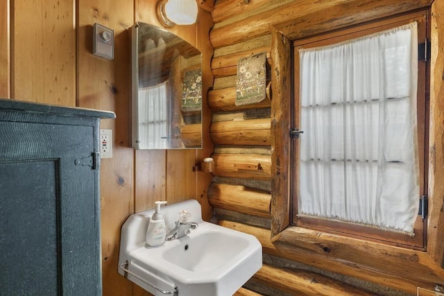 1400 Michigan Ave, East Jordan, MI 49727 - bathroom featuring log walls and a sink