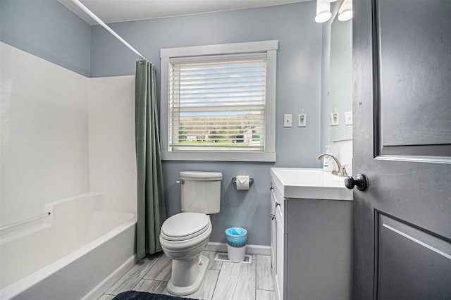 3190 Spring Dr, Boyne Falls, MI 49713 - full bath with toilet, vanity, shower / bath combo, wood finish floors, and baseboards