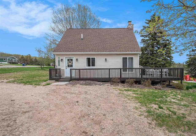3190 Spring Dr, Boyne Falls, MI 49713 - back of house with a deck, a chimney, and roof with shingles