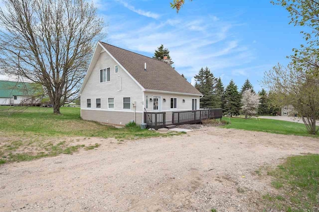 3190 Spring Dr, Boyne Falls, MI 49713 - view of property exterior featuring a deck, a yard, and a shingled roof