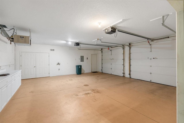 4070 Carriage House Dr Unit 5 & 6, Bay Harbor, MI 49770 - garage featuring a garage door opener and electric panel