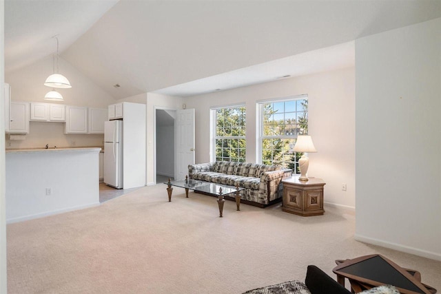 4070 Carriage House Dr Unit 5 & 6, Bay Harbor, MI 49770 - living room featuring light carpet, baseboards, and lofted ceiling