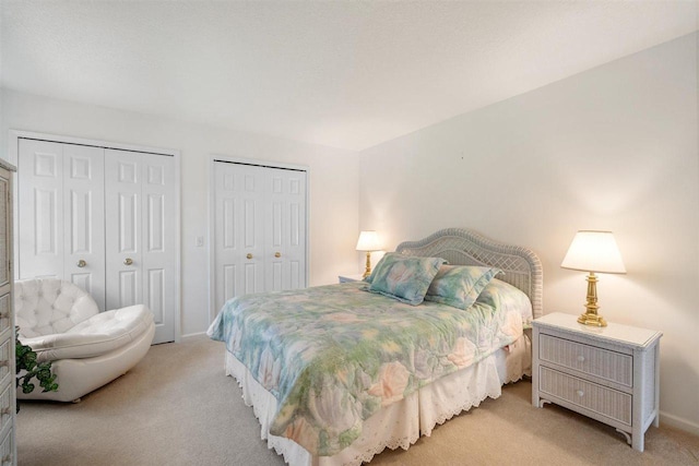 4070 Carriage House Dr Unit 5 & 6, Bay Harbor, MI 49770 - bedroom with two closets, light colored carpet, and baseboards