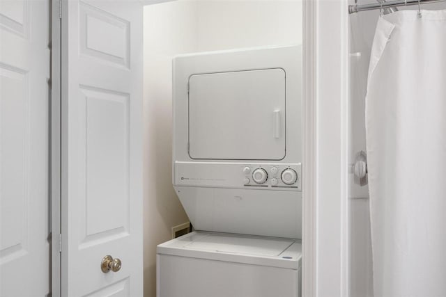 4070 Carriage House Dr Unit 5 & 6, Bay Harbor, MI 49770 - laundry room featuring stacked washing machine and dryer