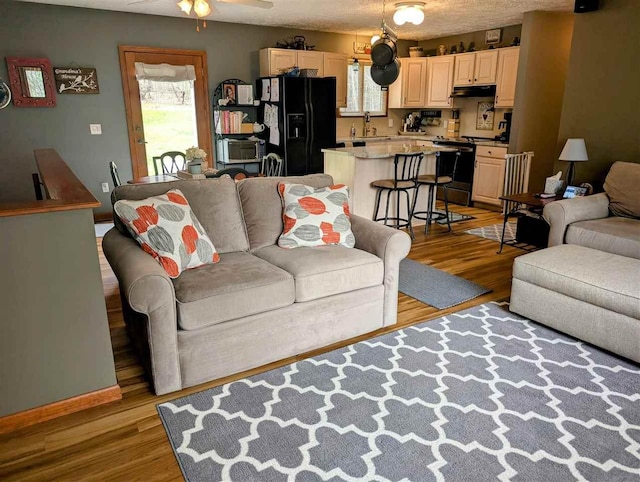 2280 S Eckhardt Rd, Bellaire, MI 49615 - living area with light wood finished floors and a ceiling fan