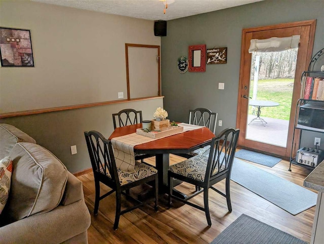 2280 S Eckhardt Rd, Bellaire, MI 49615 - dining space with light wood-type flooring and baseboards