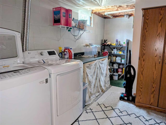 2280 S Eckhardt Rd, Bellaire, MI 49615 - laundry room featuring washing machine and clothes dryer and concrete block wall