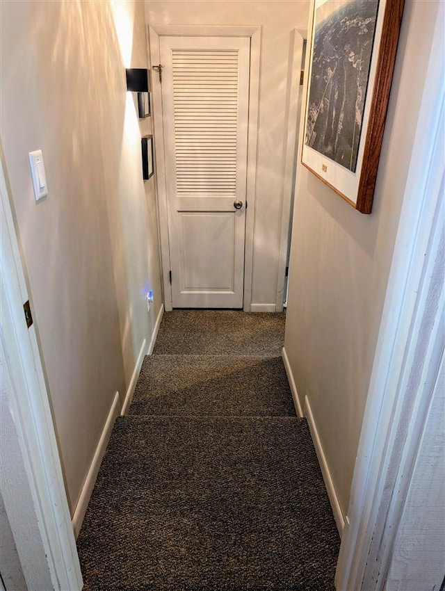 5350 Golfview Rd, Bellaire, MI 49615 - hall featuring dark carpet and baseboards