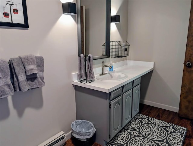 5350 Golfview Rd, Bellaire, MI 49615 - bathroom with a baseboard radiator, vanity, and wood finished floors