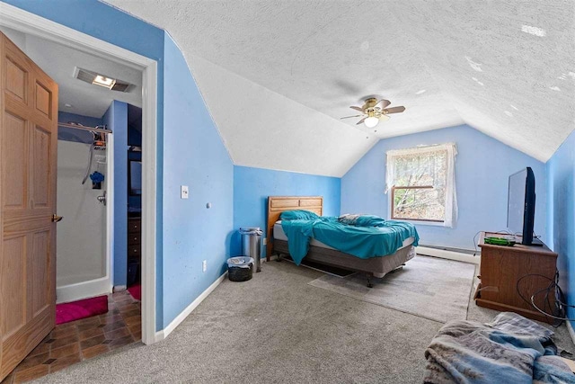 512 NW Kalkaska St, Kalkaska, MI 49646 - bedroom featuring vaulted ceiling, carpet, a baseboard heating unit, a textured ceiling, and baseboards