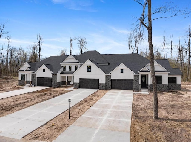 modern inspired farmhouse featuring stone siding, concrete driveway, an attached garage, and board and batten siding