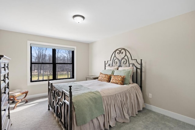 carpeted bedroom featuring baseboards