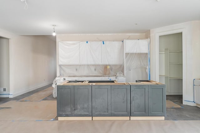 kitchen with baseboards and concrete flooring