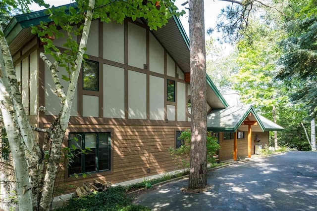 998 N Shr, Walloon Lake, MI 49796 - view of side of home featuring stucco siding